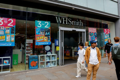 People walk past a WH Smith store in Manchester